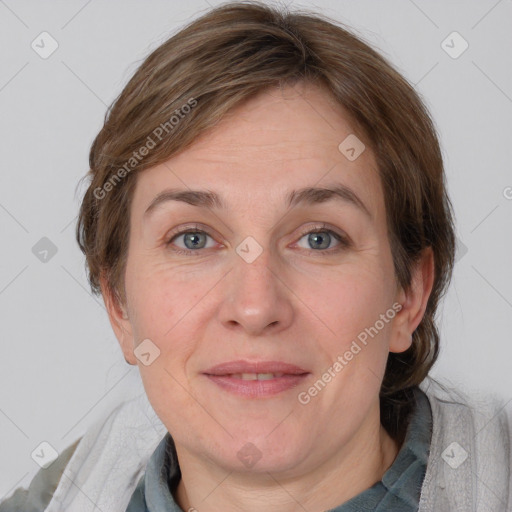 Joyful white adult female with medium  brown hair and blue eyes