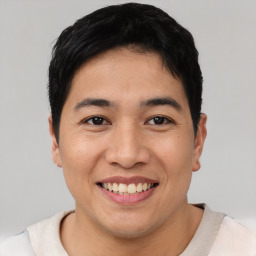 Joyful asian young-adult male with short  black hair and brown eyes