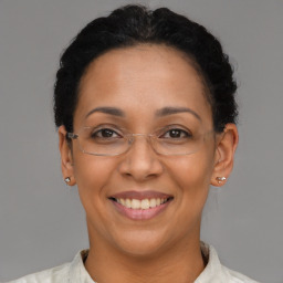 Joyful black adult female with short  brown hair and brown eyes