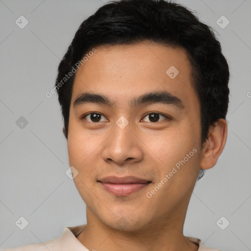 Joyful latino young-adult male with short  black hair and brown eyes