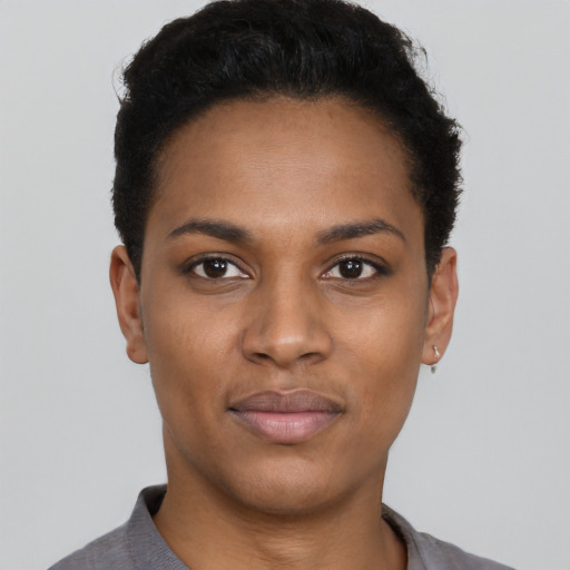 Joyful black young-adult female with short  black hair and brown eyes