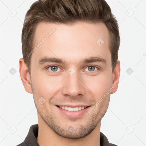 Joyful white young-adult male with short  brown hair and grey eyes