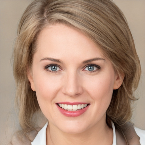 Joyful white young-adult female with medium  brown hair and blue eyes