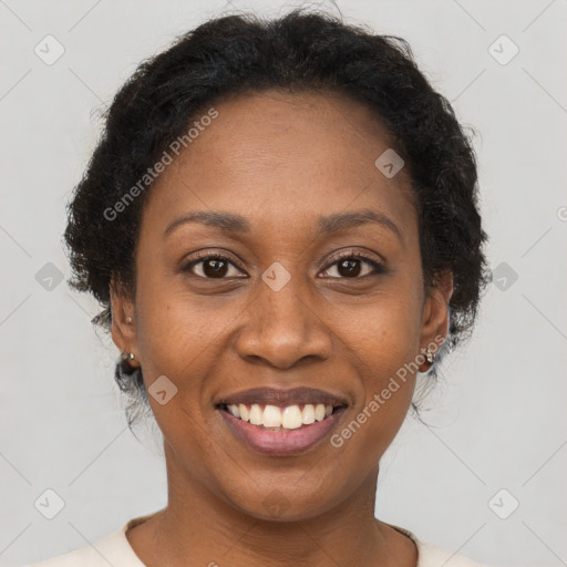 Joyful black adult female with short  brown hair and brown eyes