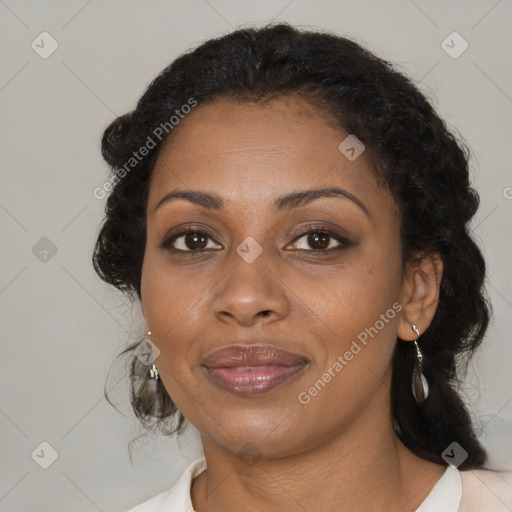 Joyful black adult female with medium  brown hair and brown eyes