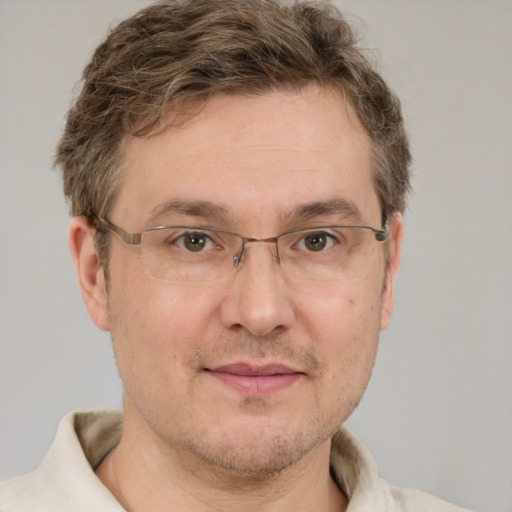 Joyful white adult male with short  brown hair and grey eyes