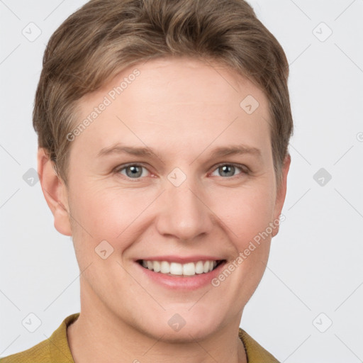 Joyful white young-adult female with short  brown hair and grey eyes