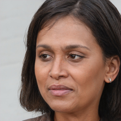 Joyful white adult female with medium  brown hair and brown eyes