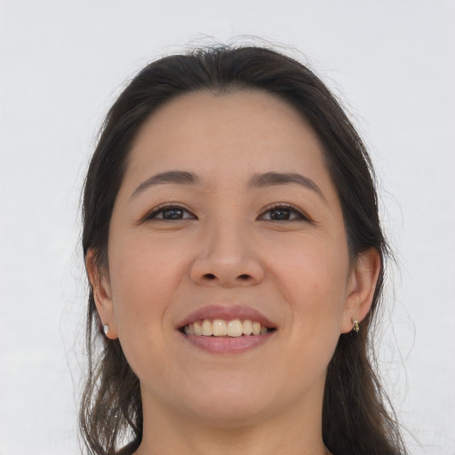 Joyful asian young-adult female with long  brown hair and brown eyes