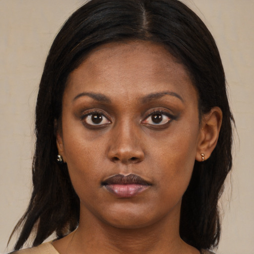 Neutral black young-adult female with medium  brown hair and brown eyes