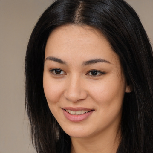 Joyful asian young-adult female with long  black hair and brown eyes