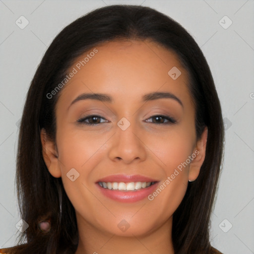 Joyful latino young-adult female with long  brown hair and brown eyes