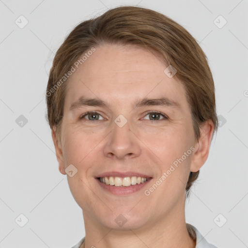 Joyful white adult male with short  brown hair and grey eyes