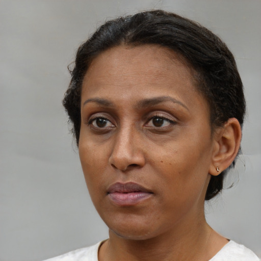 Neutral latino adult female with short  brown hair and brown eyes