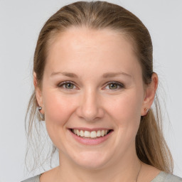 Joyful white young-adult female with medium  brown hair and grey eyes