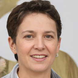 Joyful white adult female with short  brown hair and brown eyes