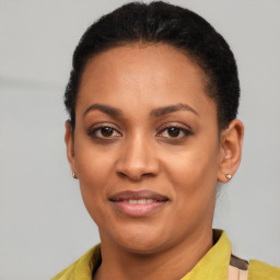 Joyful latino young-adult female with short  black hair and brown eyes