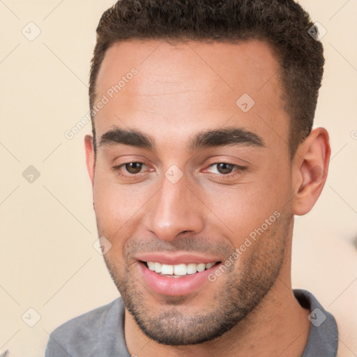 Joyful white young-adult male with short  brown hair and brown eyes