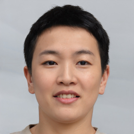 Joyful asian young-adult female with short  black hair and brown eyes