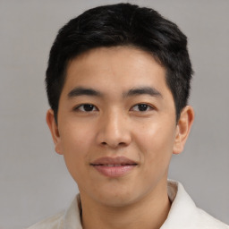 Joyful asian young-adult male with short  black hair and brown eyes