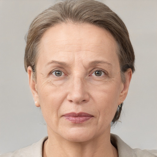 Joyful white adult female with short  brown hair and grey eyes