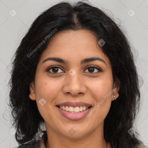 Joyful latino young-adult female with long  brown hair and brown eyes