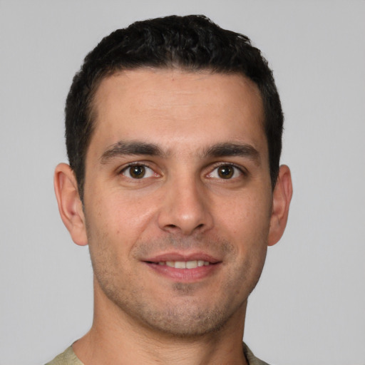 Joyful white young-adult male with short  brown hair and brown eyes