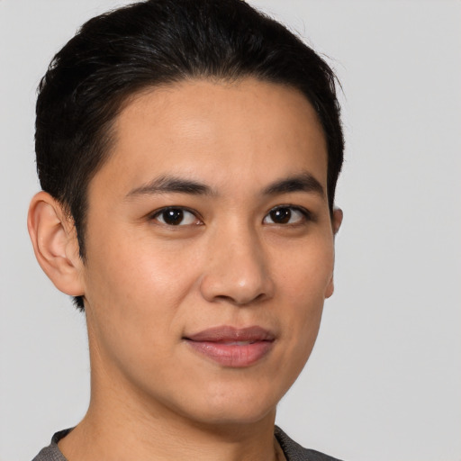 Joyful latino young-adult male with short  brown hair and brown eyes