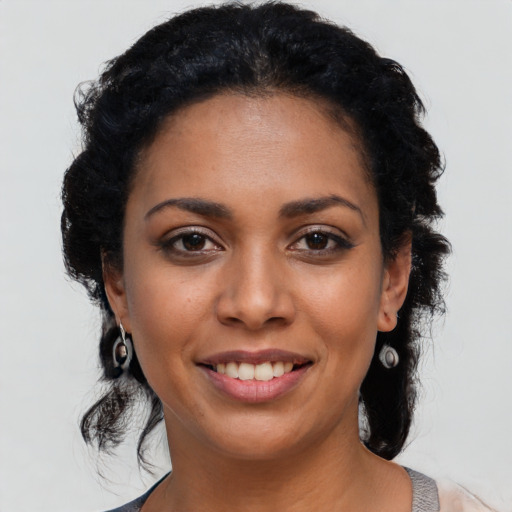 Joyful latino young-adult female with long  black hair and brown eyes