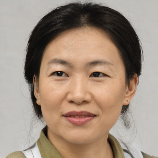 Joyful asian adult female with medium  brown hair and brown eyes