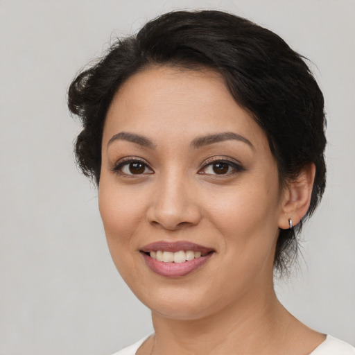 Joyful latino young-adult female with medium  black hair and brown eyes
