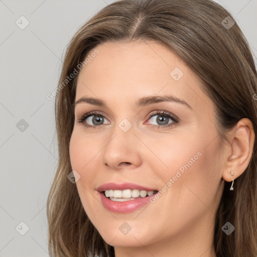 Joyful white young-adult female with long  brown hair and grey eyes