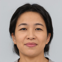 Joyful asian adult female with medium  brown hair and brown eyes