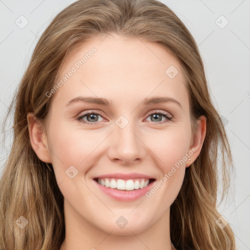 Joyful white young-adult female with long  brown hair and blue eyes