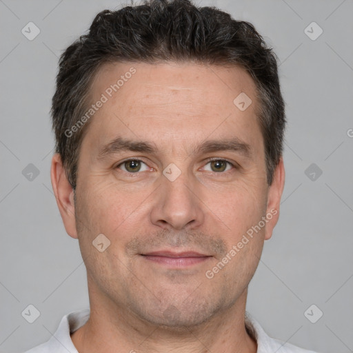 Joyful white adult male with short  brown hair and brown eyes