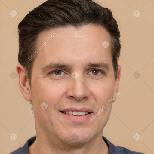 Joyful white adult male with short  brown hair and brown eyes