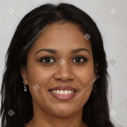 Joyful black young-adult female with long  brown hair and brown eyes