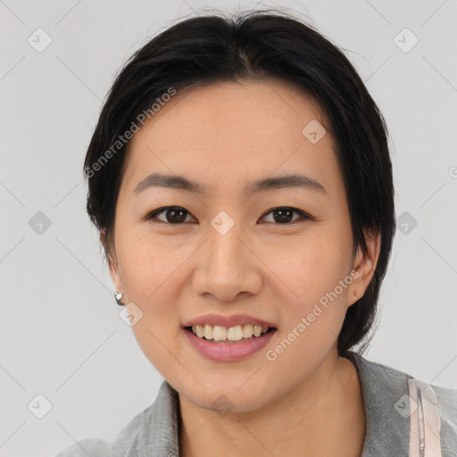 Joyful asian young-adult female with medium  black hair and brown eyes