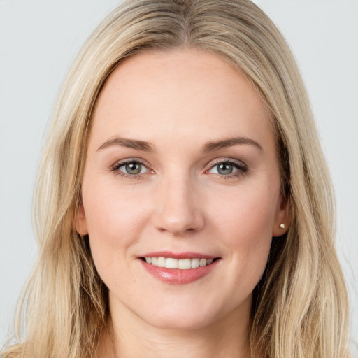 Joyful white young-adult female with long  brown hair and blue eyes