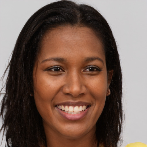 Joyful white young-adult female with long  brown hair and brown eyes