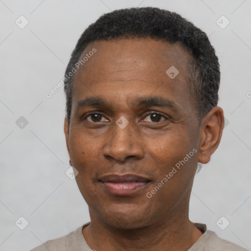 Joyful black adult male with short  black hair and brown eyes