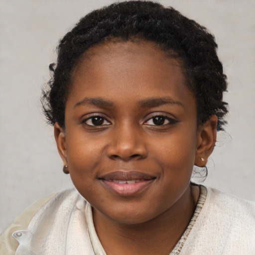 Joyful black child female with short  brown hair and brown eyes
