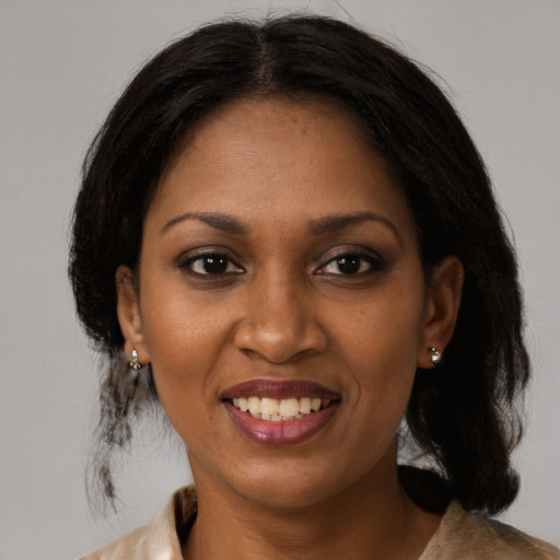 Joyful black young-adult female with medium  brown hair and brown eyes