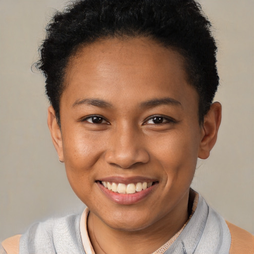 Joyful latino young-adult female with short  black hair and brown eyes