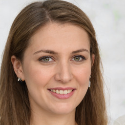 Joyful white young-adult female with long  brown hair and green eyes