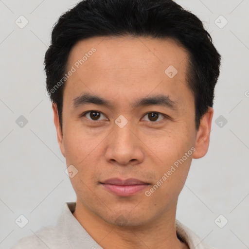 Joyful asian young-adult male with short  black hair and brown eyes