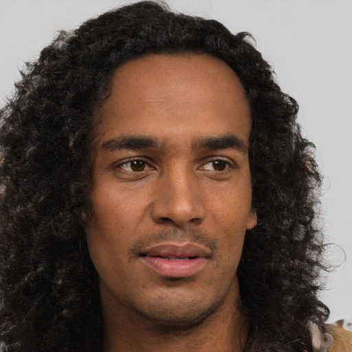 Neutral black young-adult male with long  brown hair and brown eyes