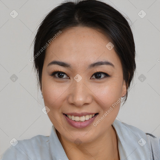 Joyful asian young-adult female with medium  black hair and brown eyes