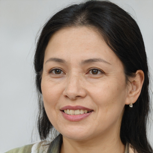 Joyful white adult female with medium  brown hair and brown eyes