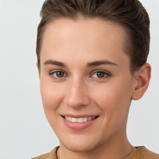 Joyful white young-adult female with short  brown hair and brown eyes